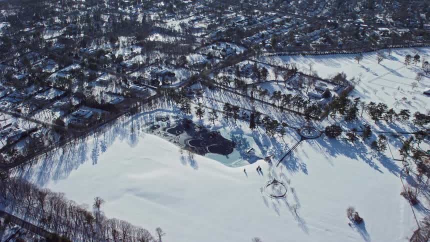 Aerial view of a park in a suburb at winter