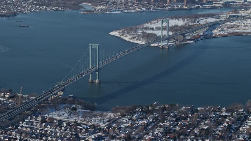 Aerial view of a residential city with a bridge connecting cities by the seaside
