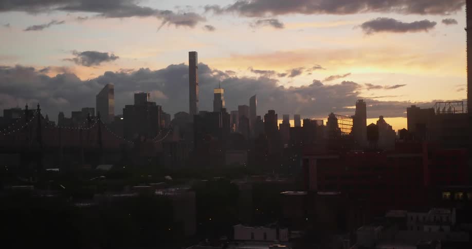 Timelapse of clouds floating over several skyscrapers