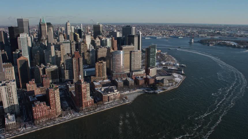A metropolitan city with huge buildings that faces the sea
