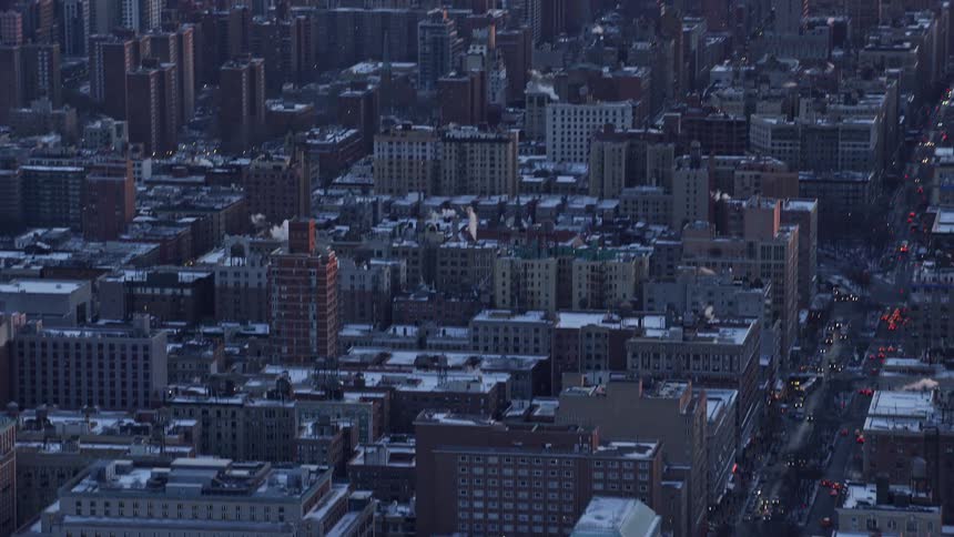 Aerial view of a metropolitan city by the seaside with an orange morning sky