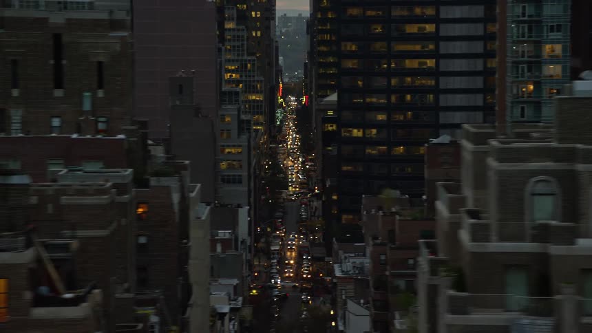 Aerial view of a metropolis with busy streets during the late afternoon