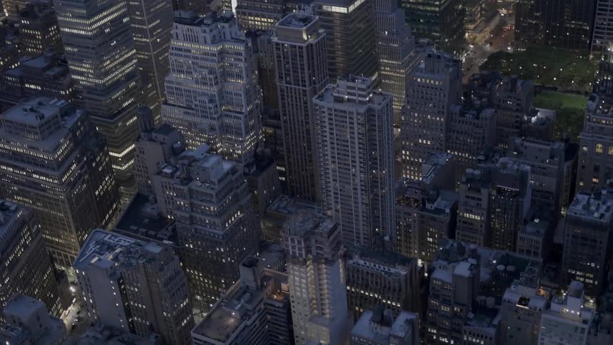 A city has many tall buildings brightly lit