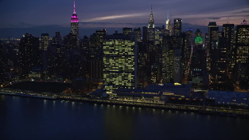 Skyline of a metropolitan city with towers illuminated at night