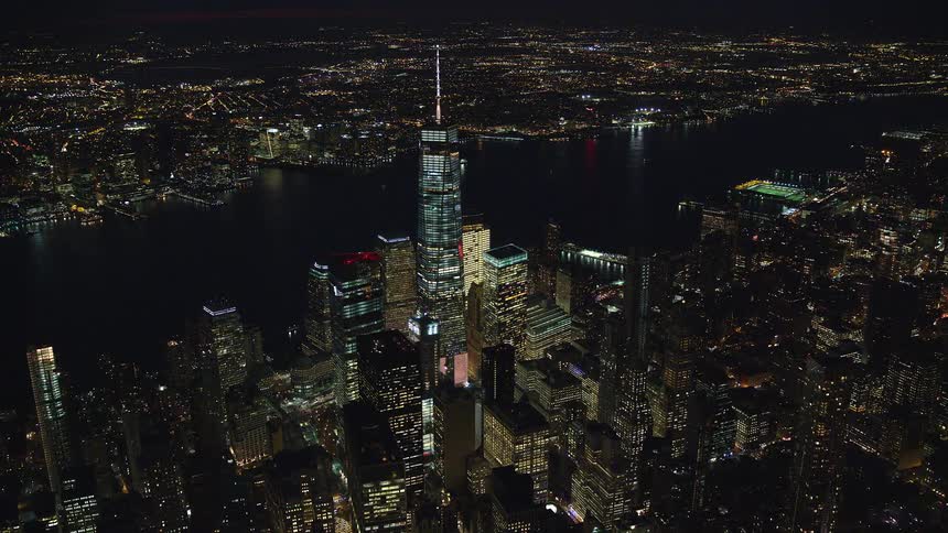 Aerial panorama of a metropolitan city at night by the seaside