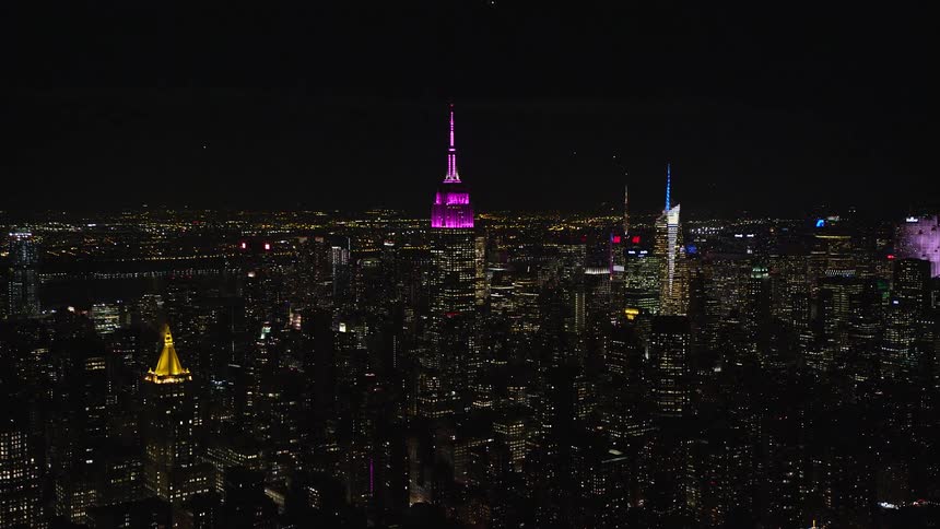 A city view at night with lights shining off from buildings