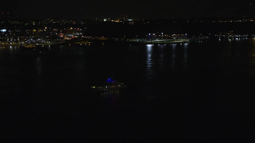 Aerial view of a yacht by the seaside at night