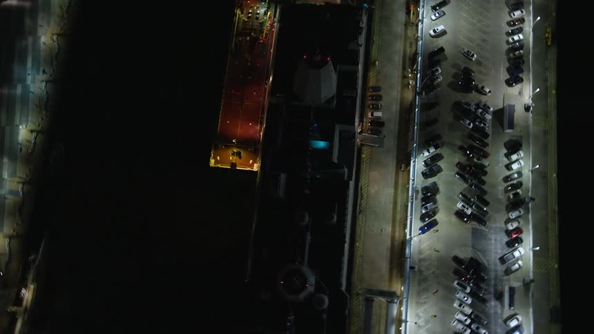 Aerial panorama of a cruise ship docked at the port at night