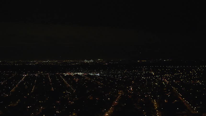 An aerial view of a city with a residential region at night