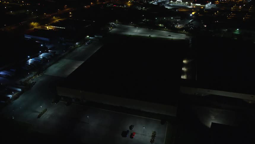 Nighttime view of an establishment in the midst of the city