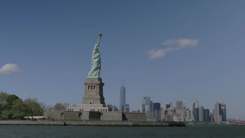 The statue of liberty sits in a clear sky