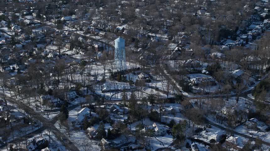 Aerial view of a water tower in the middle of a town