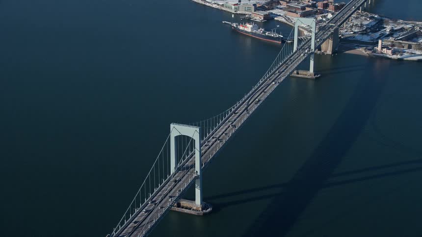 Aerial panorama of a bridge spanning the sea in cities