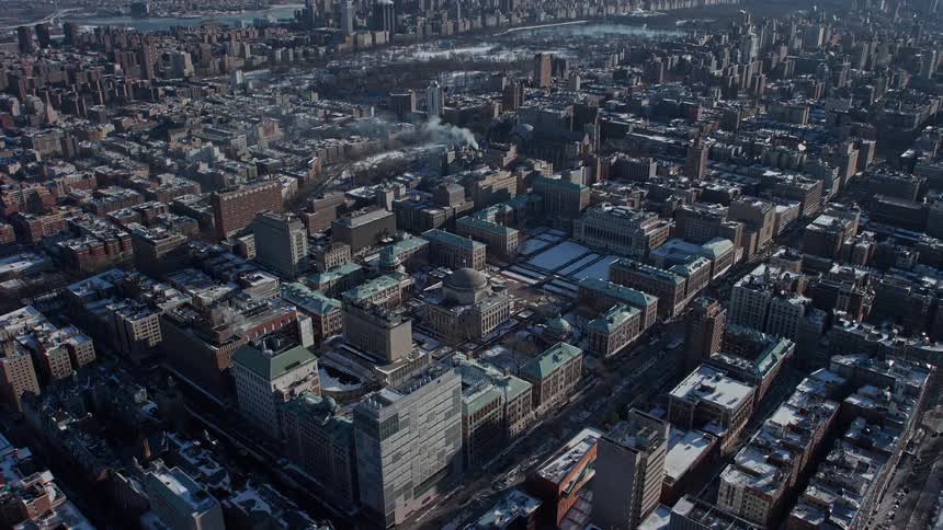 Aerial view of a metropolitan city in winter with snow by the seaside