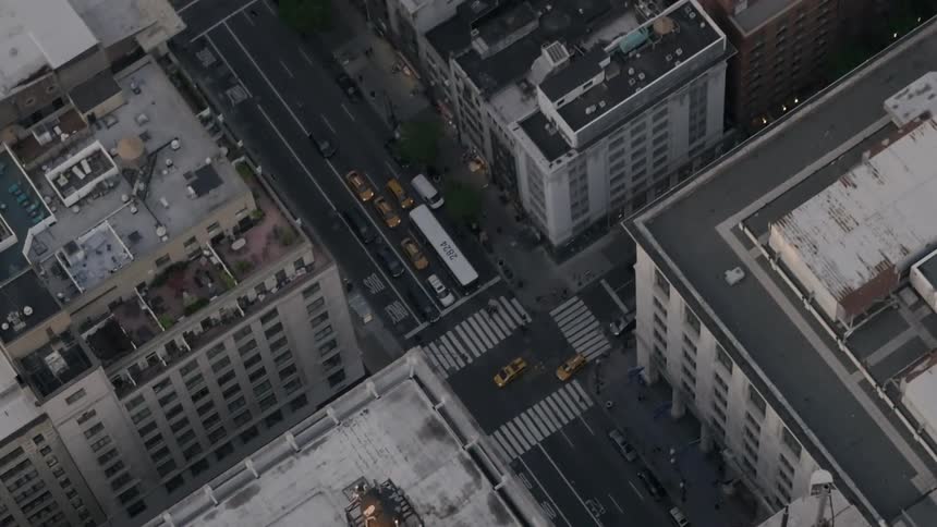 Cars drive in the streets of the city below