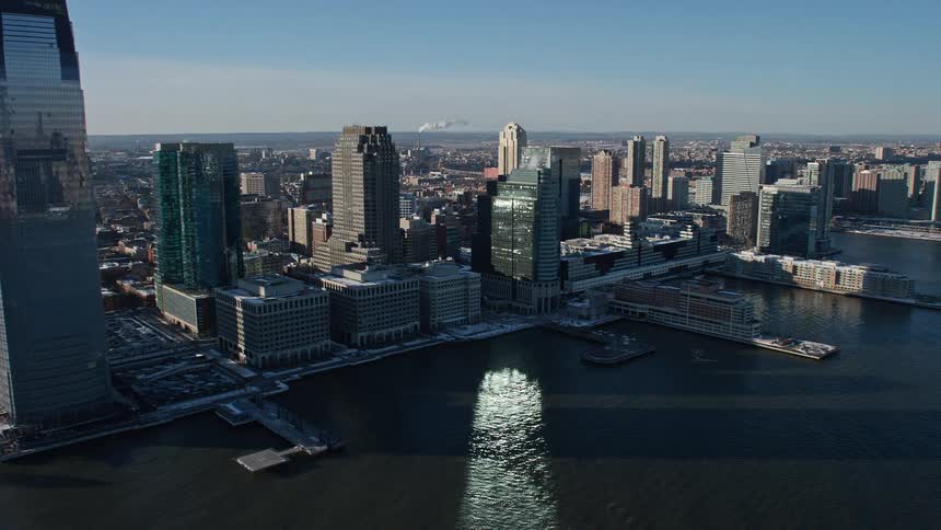 Water near city waterfront reflects sunlight