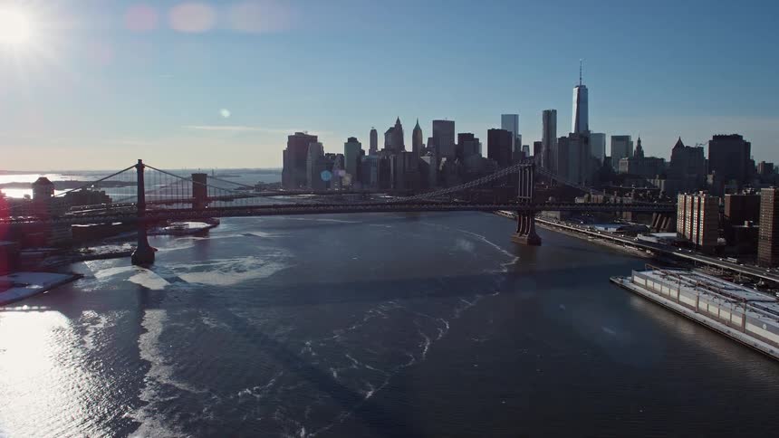 A bridge linking two city with cars going by on a sunny day in the winter season