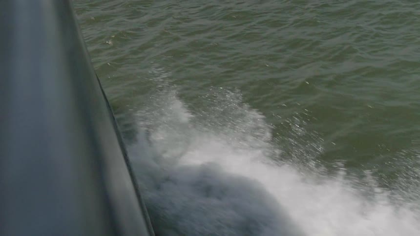 A boat is splashing water as it travels