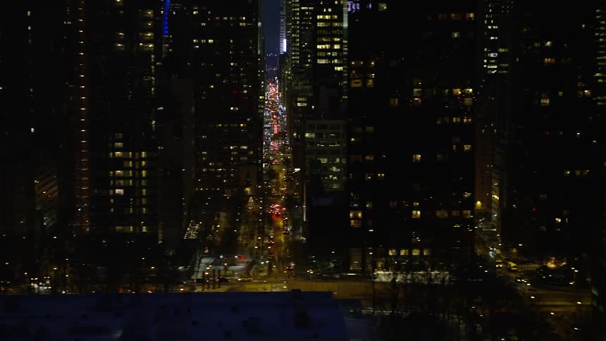 View of streets in the midst of a metropolis with buildings and skyscrapers at night