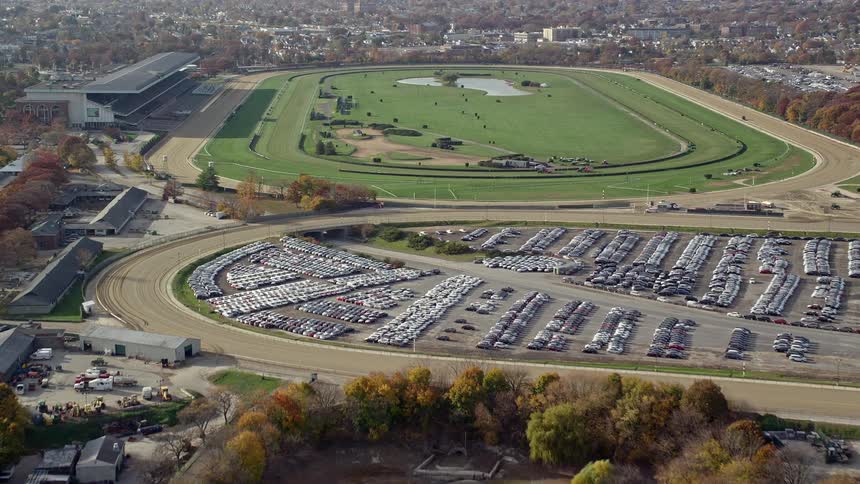 A grass field and a huge car park next door