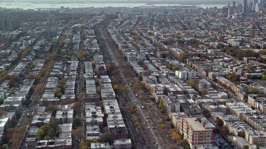 Aerial panorama of an urban city by the seaside with a central highway