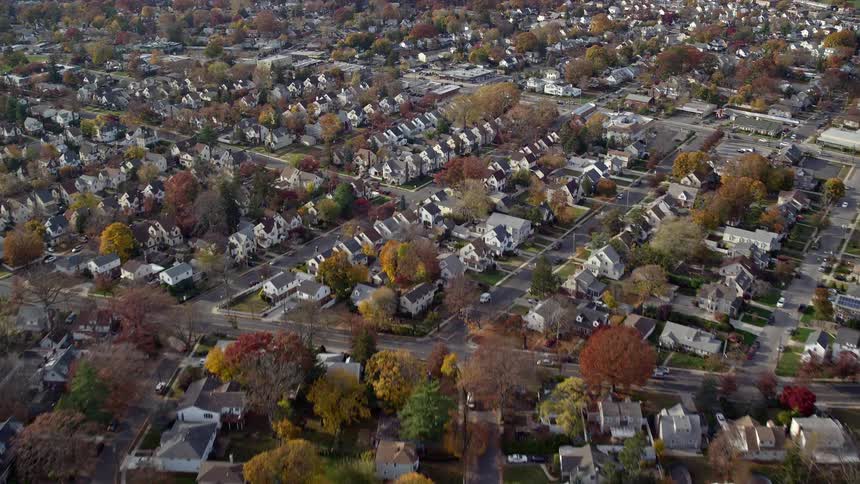 Aerial of houses and trees in a suburban area during the day