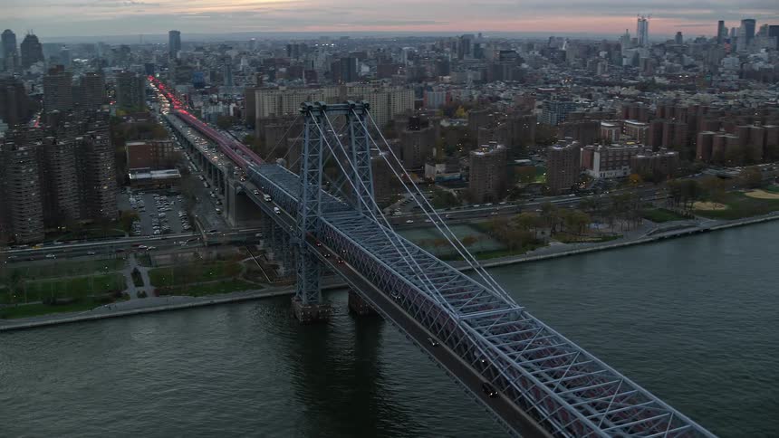 Aerial view of a metropolitan city with a central bridge spanning the sea