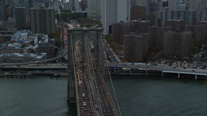 Traffic is running on the bridge by the city