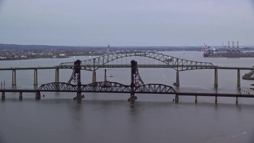 An aerial view of a bridge joining two sea shores