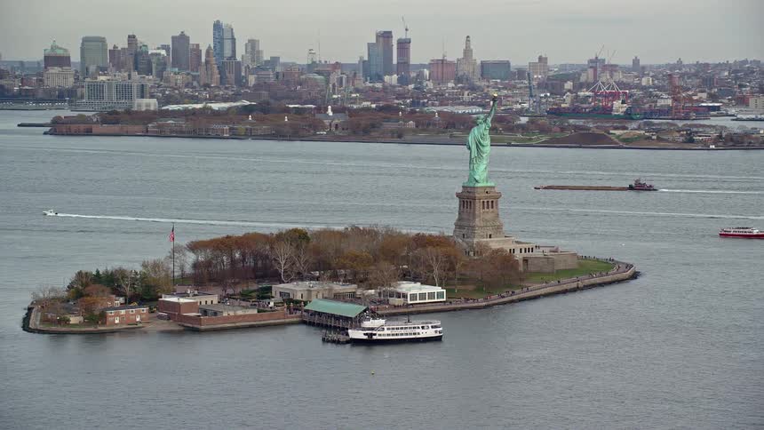 Aerial view of a statue of liberty on an island in the middle of the sea