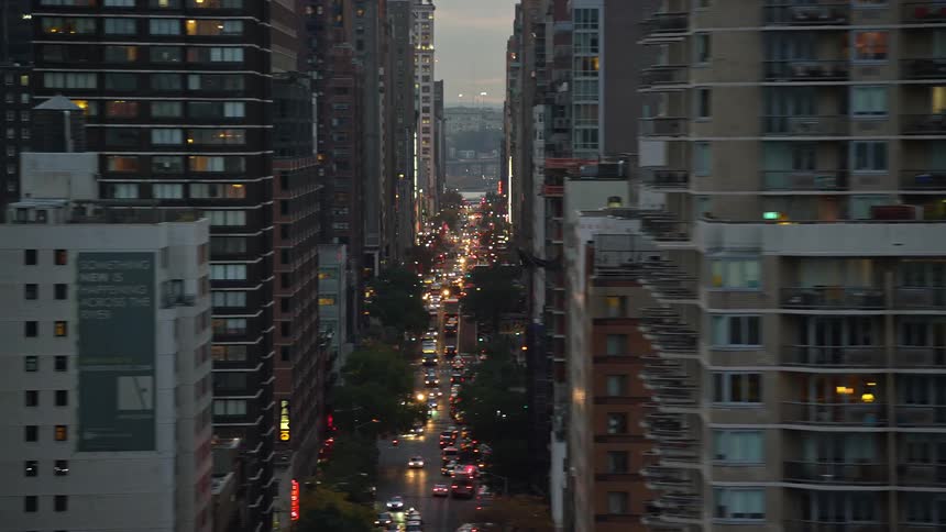 A city with tall buildings and streets very busy with vehicles