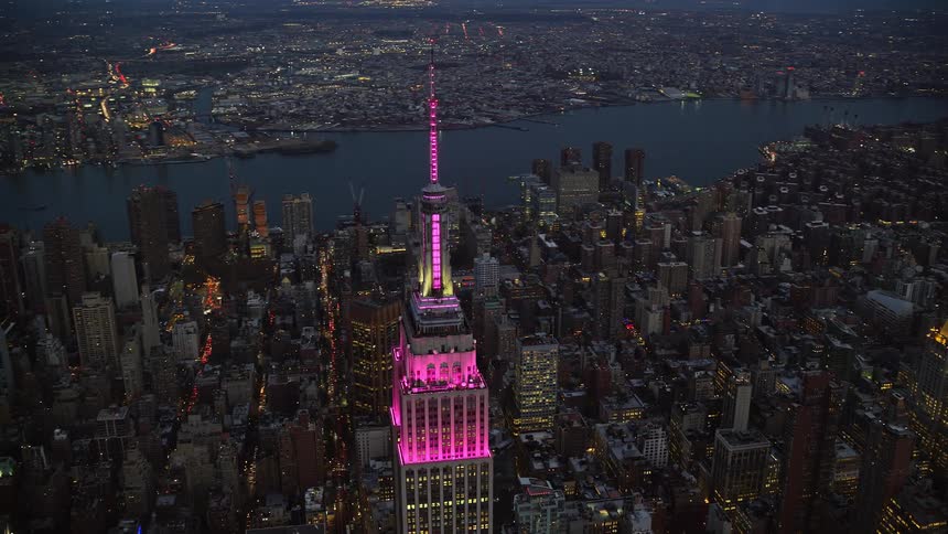 Aerial architecture of illuminated skyscrapers with pink lights in a metropolis at night