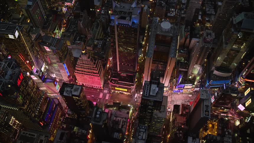 Aerial panorama of a metropolitan city with illuminated billboards