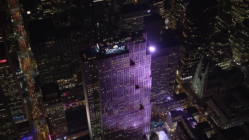 Aerial view of a metropolitan building with purple lighting at night