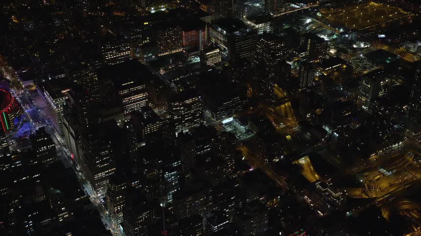 Aerial view of illuminated buildings at night in a metropolis