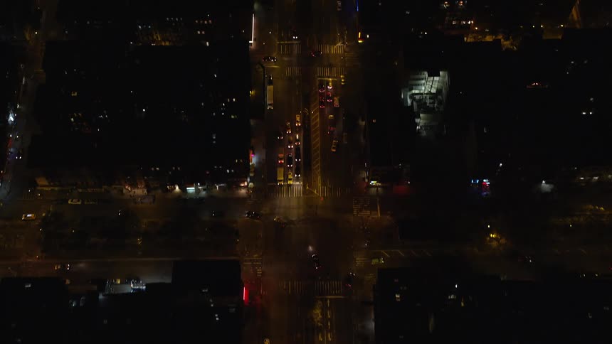 Aerial nighttime panorama of a city and its highways