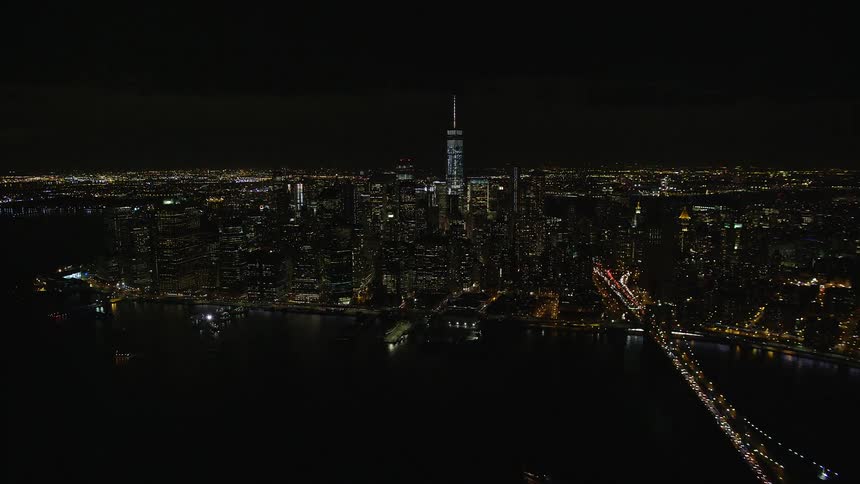 A metropolitan region at night and a bridge with lights