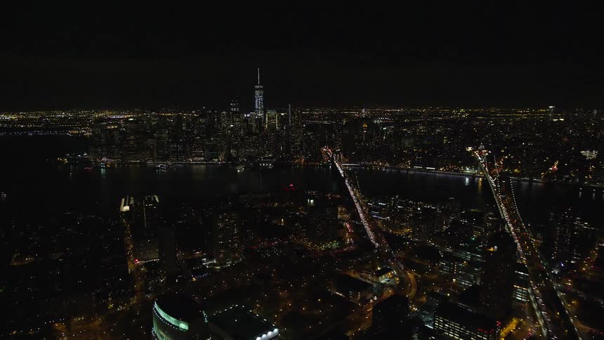 A huge city with tall buildings at night and many house lights on