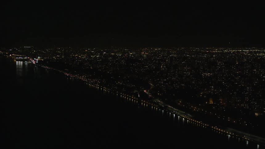 A huge city at night where the lights of the houses and buildings are on