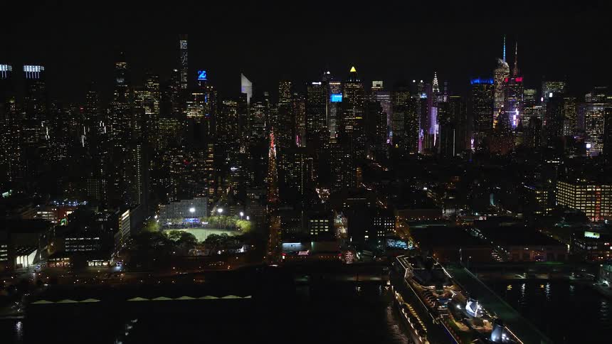 Skyline of a city with port area at night