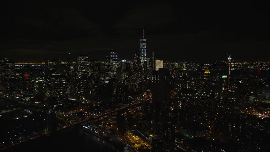A metropolitan city at night with building lights on