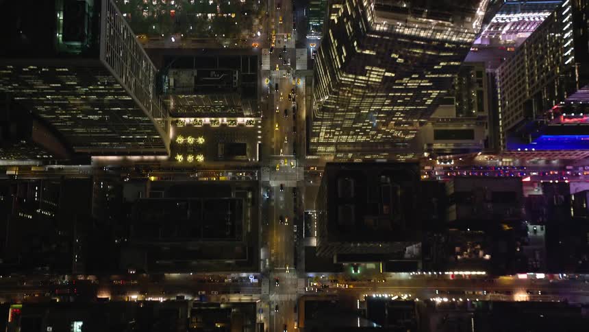 Aerial panorama of a nighttime metropolitan city with its streets