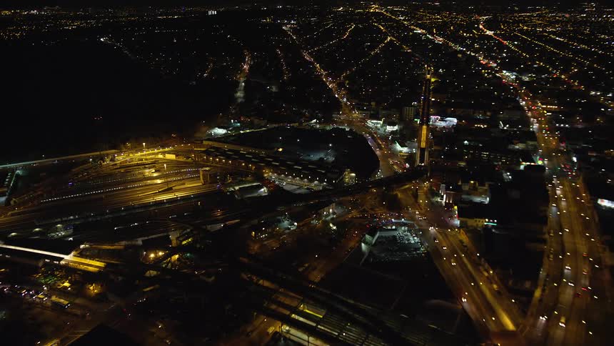 Aerial view of a metropolitan city with illuminated streets at night