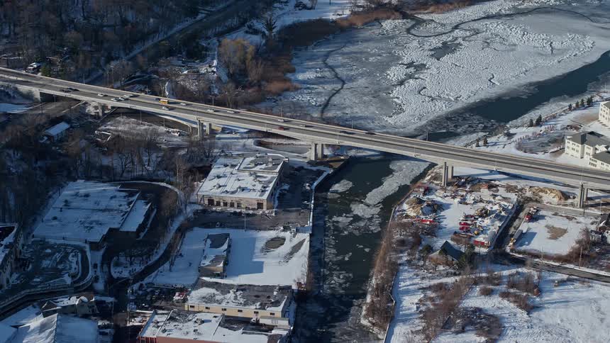 Skyline of a bridge in a neighborhood with ice and snow during the day