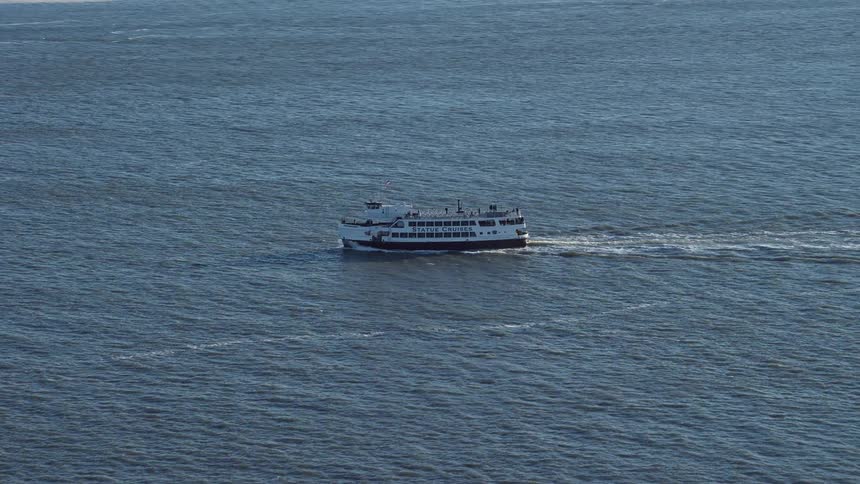 A cruise ship with many passengers sails across the water