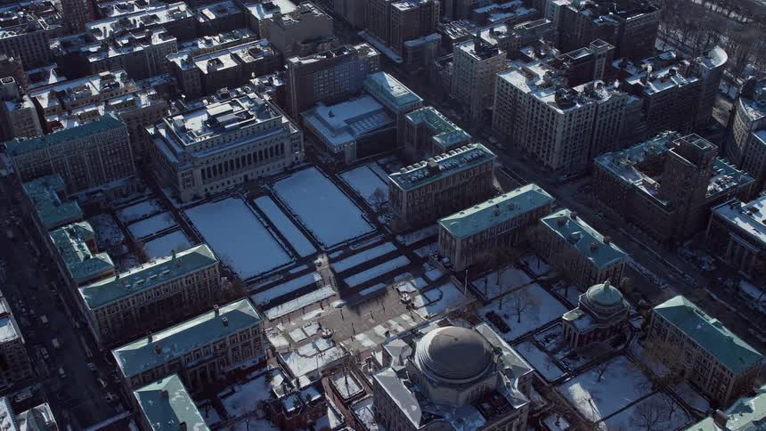 Aerial view of a museum in the midst of a city covered in snow