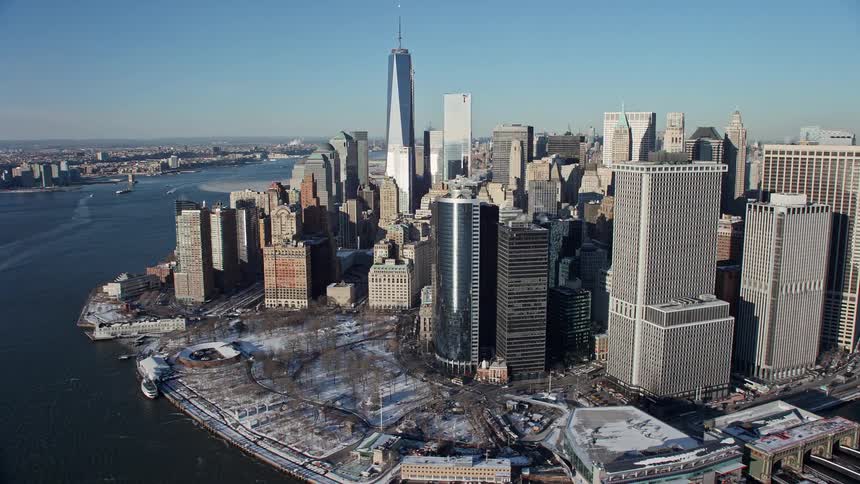 A city view with skyscrapers and tower block close to a river bank