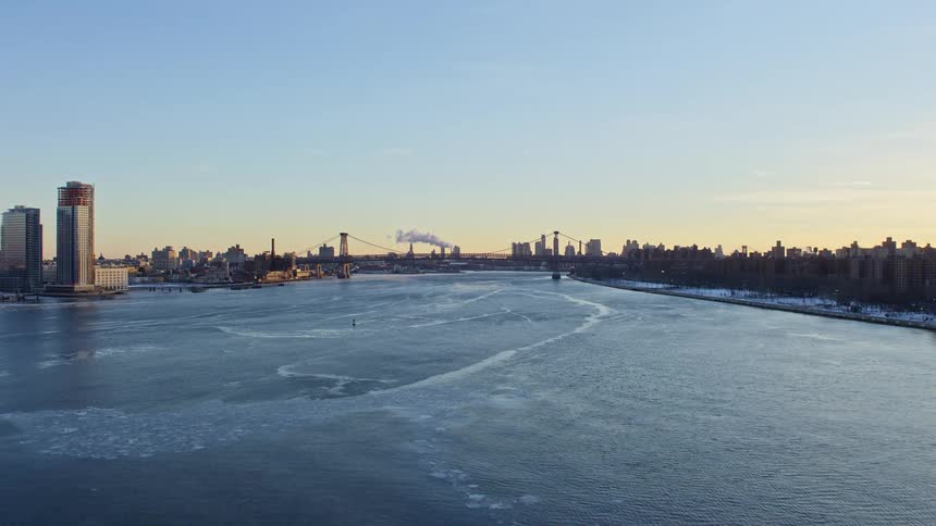 View of the sea surrounded by a metropolis with a morning sky