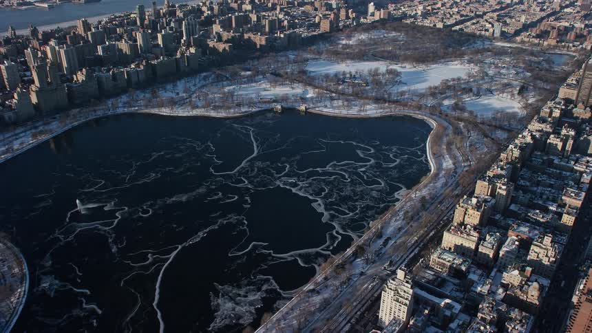 Aerial of central park with frozen lake during winter
