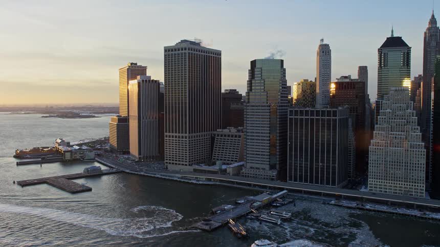 Aerial view of skyscrapers by the seaside with morning sunlight reflection